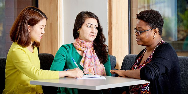 University of Leeds international students having a conversation with academic