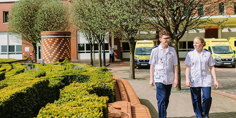 Two healthcare students walking outside Leeds General Infirmary.