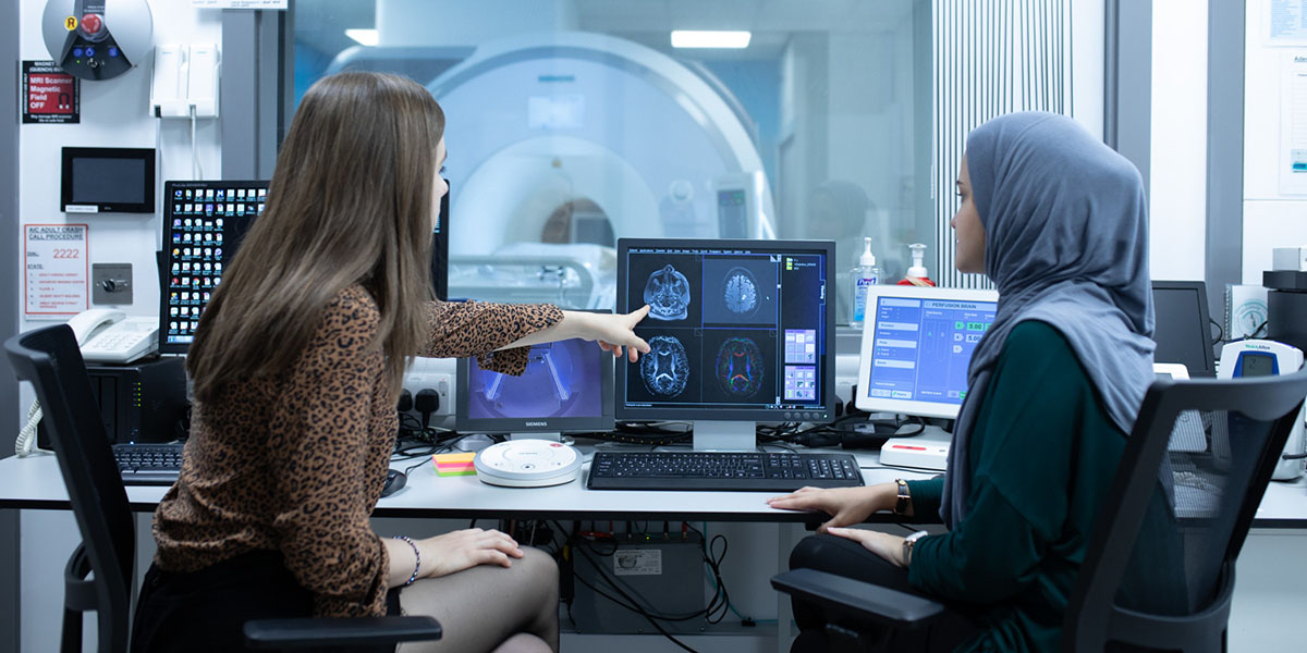 Al4 4765 two female students with the mri scanner controls