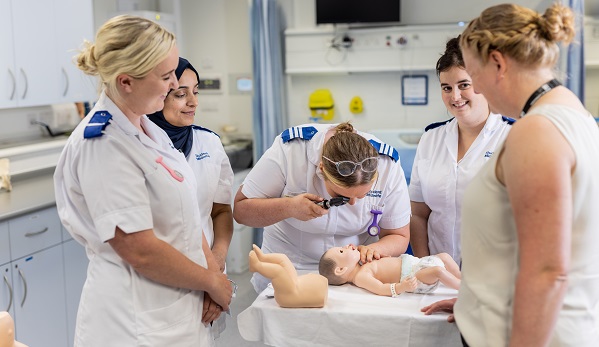 Midwifery students studying with academic