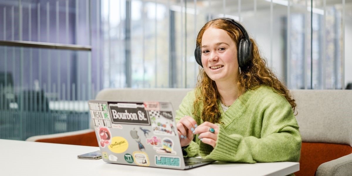 A student sits at a laptop