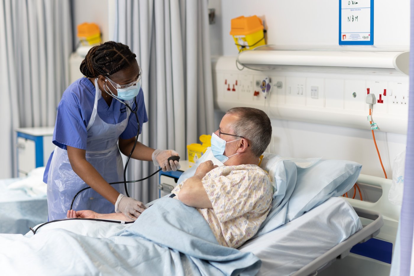 Image of a MBChB student taking the blood pressure of a patient