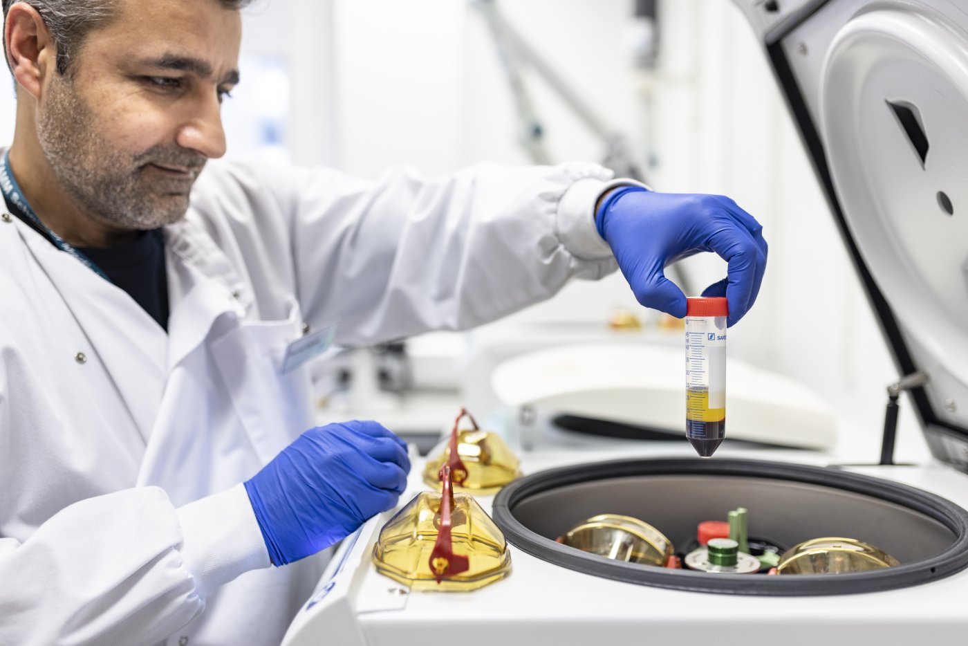 Researcher in lab with test tubes
