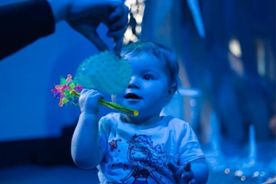 Baby playing (blue filter over image)