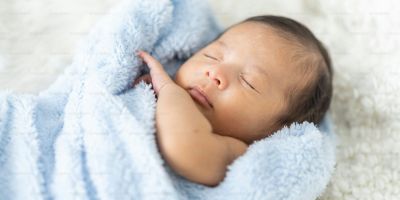 sleeping baby wrapped in towel