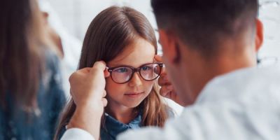 Child getting her glasses fitted
