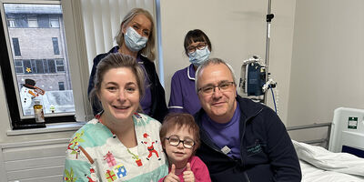 Patient Dulcie and nursing staff smiling at the camera