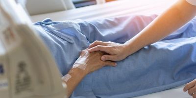 Patient having his hand held in hospice