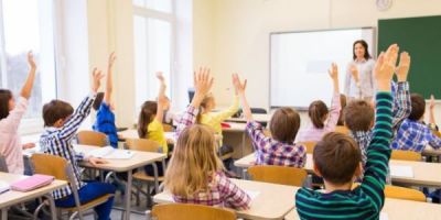 Children, classroom, raising hands, teacher at front