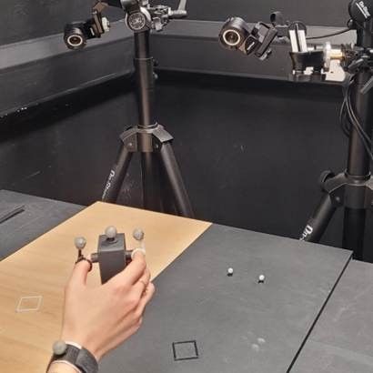 A human hand interacting with two robots