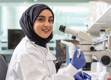 LICAMM female researcher with a microscope