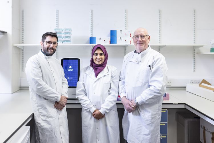 Three researchers standing together