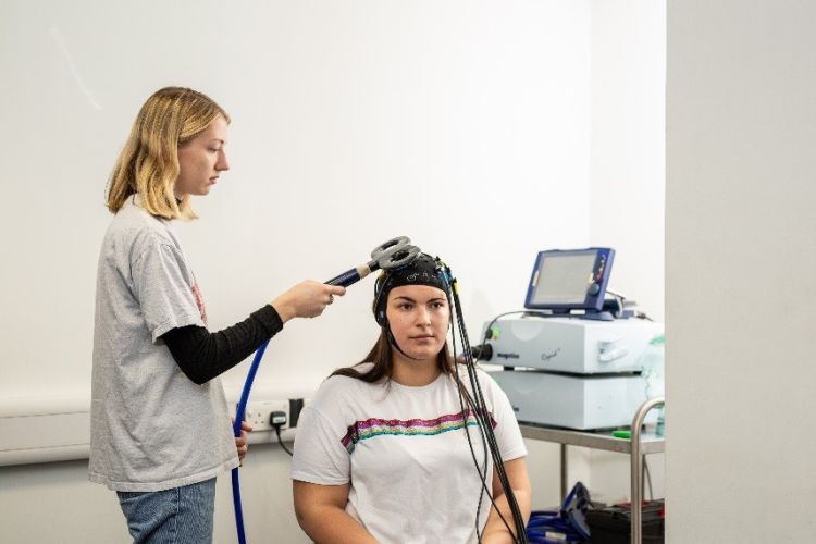 Students using Magstim rapid2 transcranial magnetic stimulator 