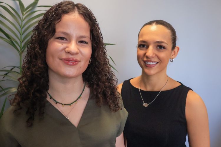 Two research interns smiling at the camera.