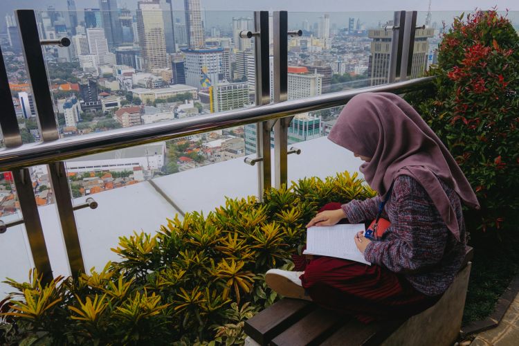 Woman wearing a hijab reading