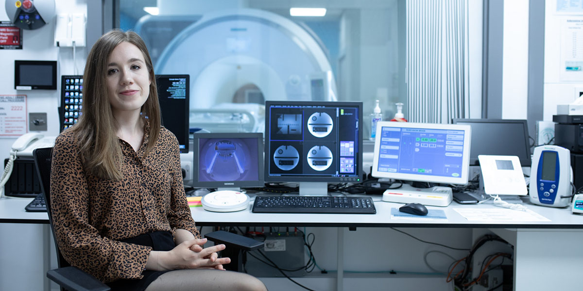 Msc student in front of mri scanner with blanks for calibration on screen