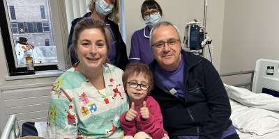 Patient Dulcie and nursing staff smiling at the camera