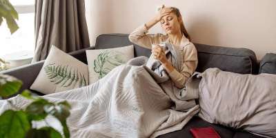Woman sitting on the sofa looking exhausted