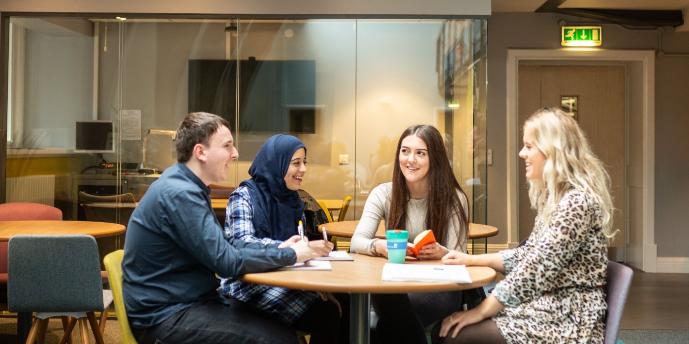 Group of mental health and social work work students sat studying in the Baines Wing at the University of Leeds