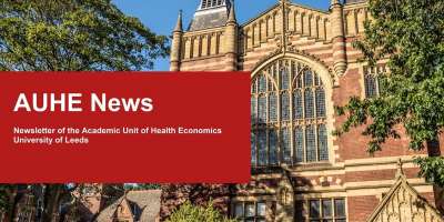 A red stone gothic building overlaid with a red box and while text for 'AUHE News',